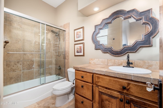 full bathroom featuring tile patterned floors, toilet, vanity, and enclosed tub / shower combo