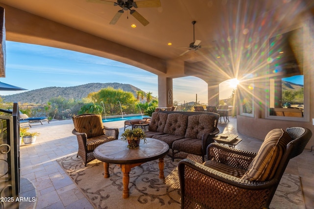 view of patio featuring an outdoor pool, a mountain view, outdoor dining area, and an outdoor hangout area
