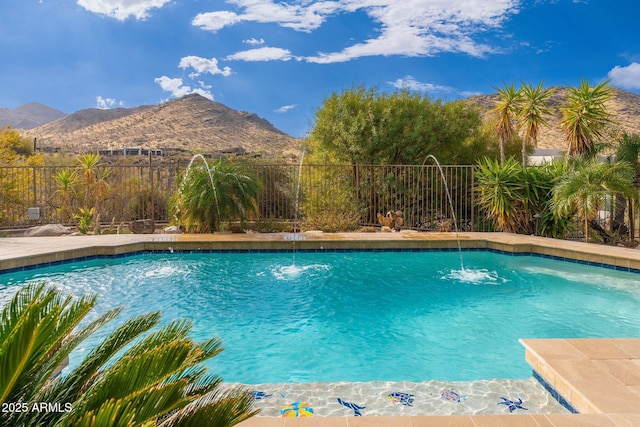 view of pool with a mountain view, a fenced backyard, and a fenced in pool
