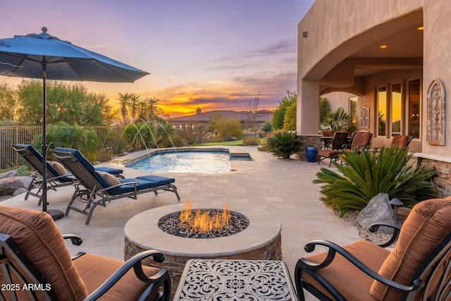 outdoor pool with an outdoor fire pit and a patio