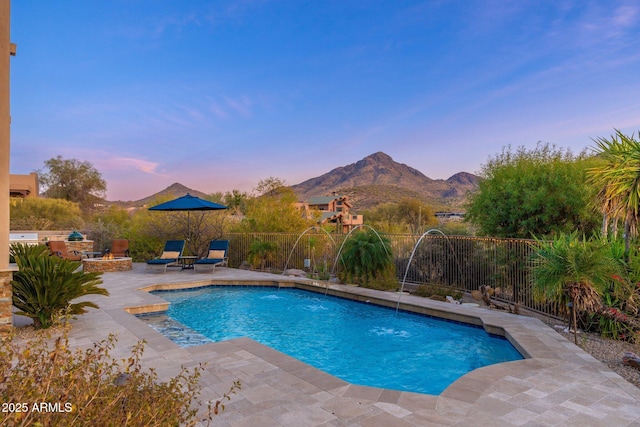 view of pool featuring a mountain view, fence, a fenced in pool, and a patio