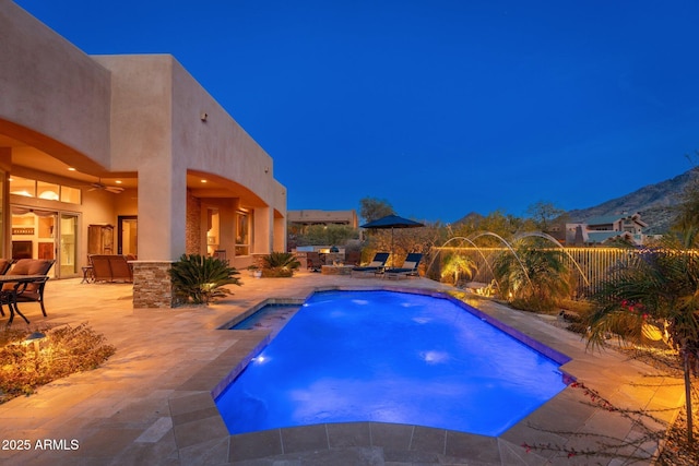 view of pool featuring a patio area, a mountain view, fence, and a fenced in pool