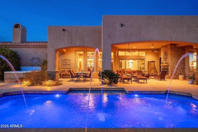 pool with a patio area and ceiling fan