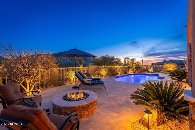view of swimming pool with an outdoor fire pit, a patio area, a fenced in pool, and a fenced backyard