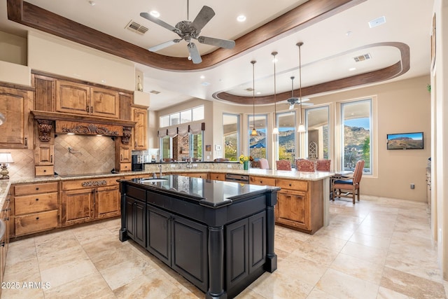kitchen featuring a center island, visible vents, and a tray ceiling