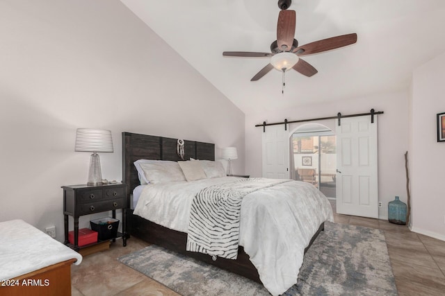 bedroom featuring ceiling fan, a barn door, light tile patterned floors, and high vaulted ceiling