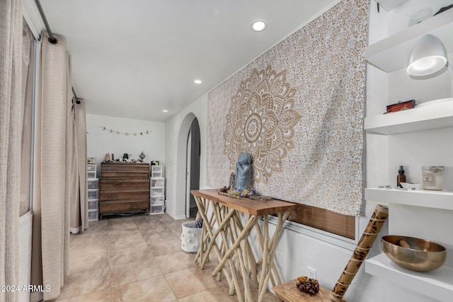 hall with light tile patterned floors