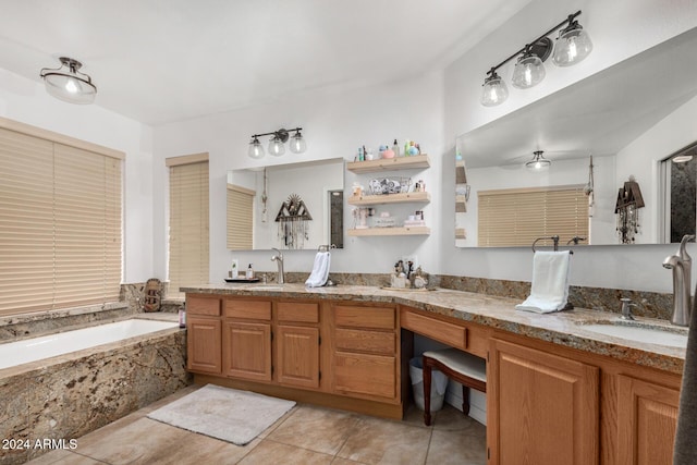 bathroom featuring tiled tub, tile patterned flooring, and vanity