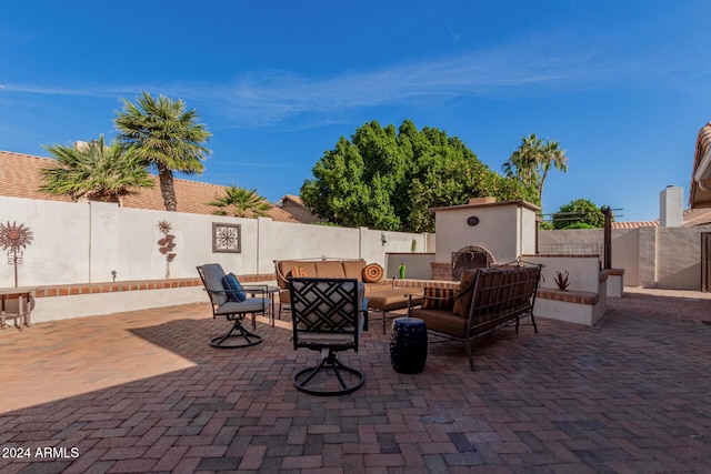 view of patio / terrace featuring an outdoor living space with a fireplace