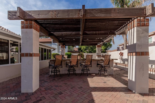 view of patio with a pergola and an outdoor bar