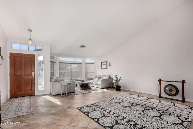 foyer featuring light tile patterned flooring and a high ceiling