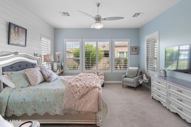 bedroom featuring a ceiling fan, light colored carpet, visible vents, and baseboards