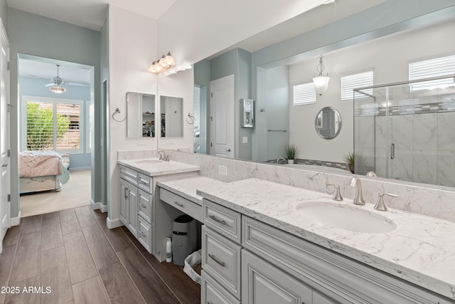 bathroom with baseboards, ensuite bath, wood tiled floor, vanity, and a shower stall