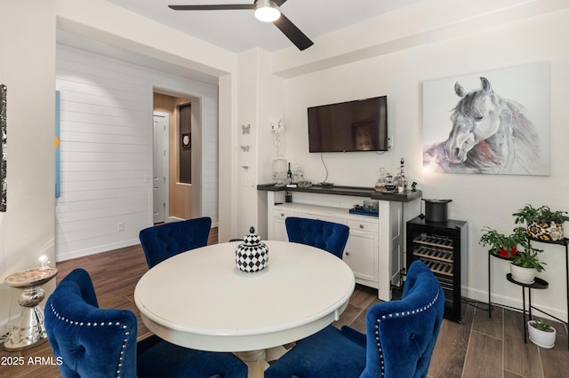 dining space with ceiling fan, dark wood finished floors, and baseboards