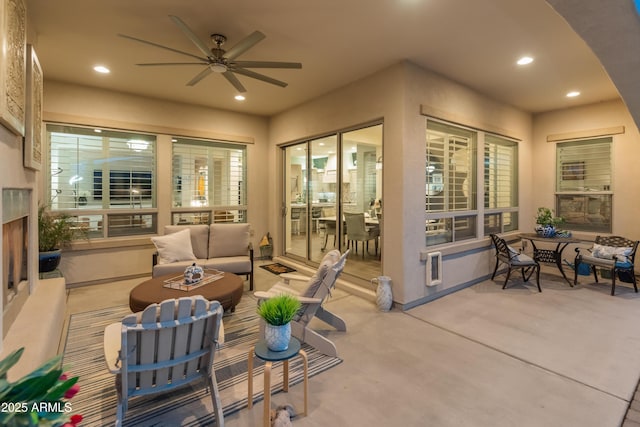 view of patio with ceiling fan and an outdoor living space