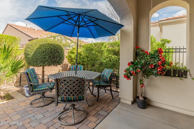 view of patio / terrace featuring outdoor dining area and fence