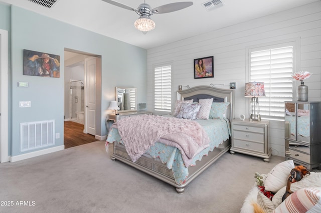 carpeted bedroom with visible vents and baseboards