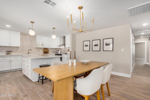 1501 E Sheridan St, Phoenix, AZ 85006 - dining room with light wood finished floors, baseboards, a chandelier, and recessed lighting