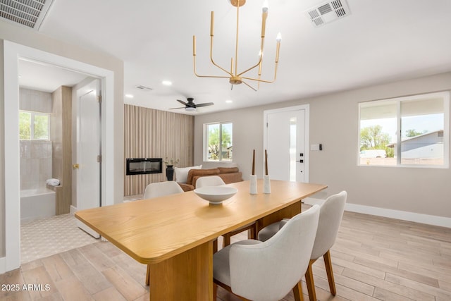 1501 E Sheridan St, Phoenix, AZ 85006 - dining area featuring light wood-type flooring, a fireplace, a chandelier, baseboards, and recessed lighting