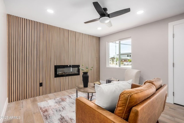 1501 E Sheridan St, Phoenix, AZ 85006 - living room with a ceiling fan, recessed lighting, wood finished floors, an accent wall, and a glass covered fireplace