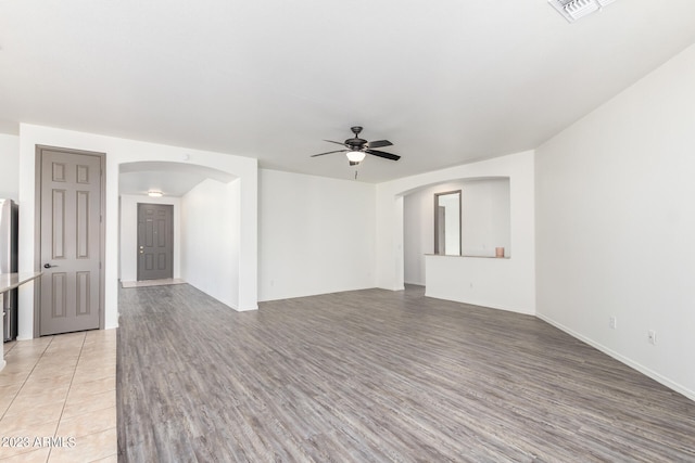 spare room featuring light hardwood / wood-style floors and ceiling fan