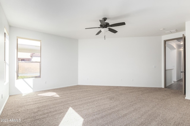 carpeted empty room featuring ceiling fan