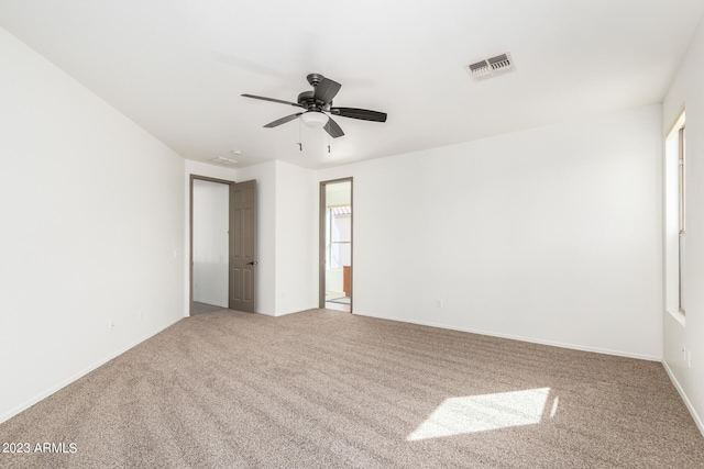 carpeted empty room featuring ceiling fan