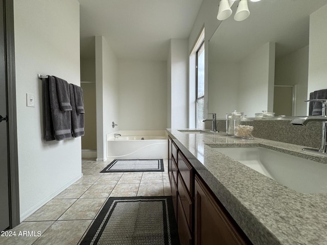 bathroom featuring vanity, tile patterned floors, and a washtub