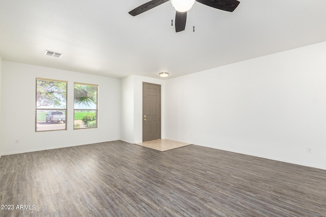 spare room with hardwood / wood-style flooring and ceiling fan