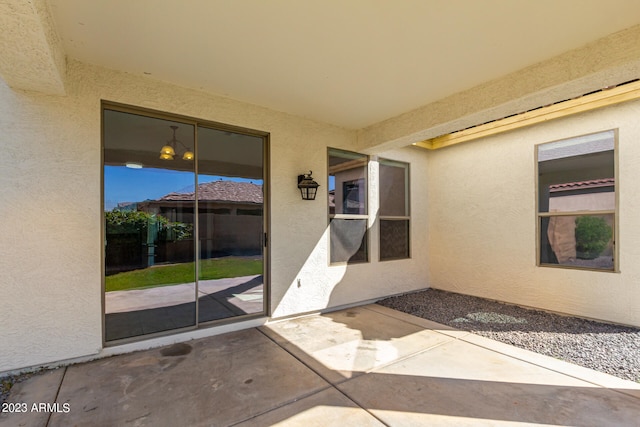 view of exterior entry featuring a patio