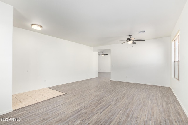 unfurnished room with light wood-type flooring and ceiling fan