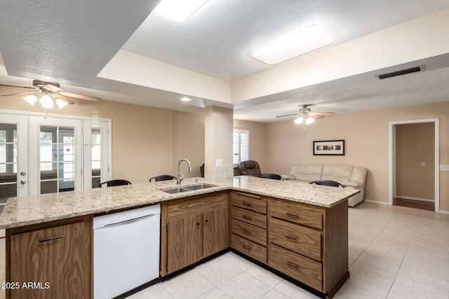 10126 W Sombrero Cir, Sun City, AZ 85373 - kitchen with dishwasher, a ceiling fan, open floor plan, a sink, and a textured ceiling
