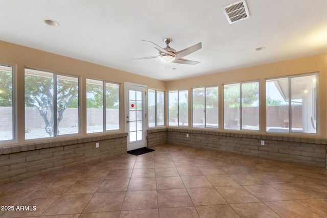 10126 W Sombrero Cir, Sun City, AZ 85373 - unfurnished sunroom featuring brick wall and tile patterned flooring