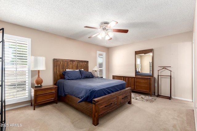 10126 W Sombrero Cir, Sun City, AZ 85373 - bedroom with light colored carpet, a textured ceiling, a ceiling fan, and baseboards
