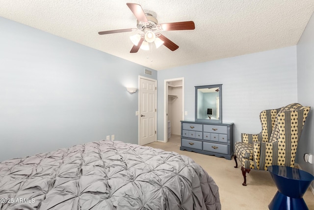 10126 W Sombrero Cir, Sun City, AZ 85373 - carpeted bedroom featuring a textured ceiling, ceiling fan, and a walk in closet