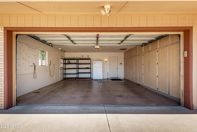 10126 W Sombrero Cir, Sun City, AZ 85373 - garage featuring freestanding refrigerator and baseboards