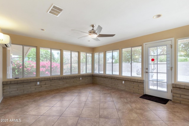 10126 W Sombrero Cir, Sun City, AZ 85373 - unfurnished sunroom with brick wall, a wall unit AC, tile patterned floors, and recessed lighting