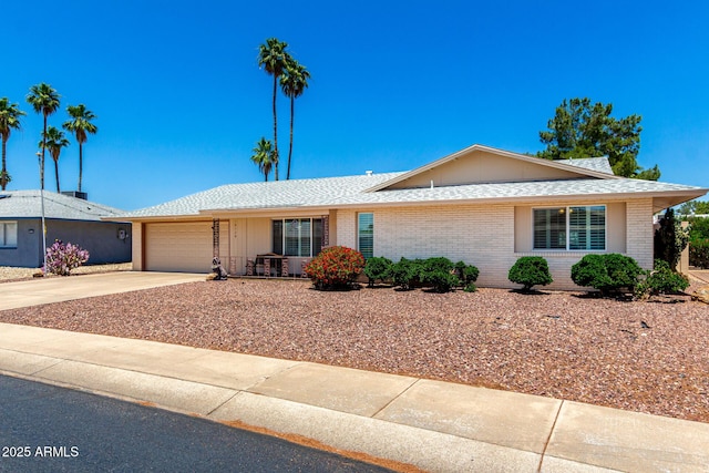10126 W Sombrero Cir, Sun City, AZ 85373 - ranch-style house featuring brick siding, concrete driveway, a garage, and roof with shingles