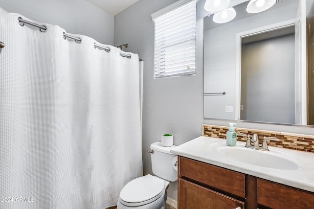 full bathroom featuring toilet, backsplash, and vanity