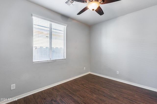 spare room with a ceiling fan, baseboards, visible vents, and wood finished floors