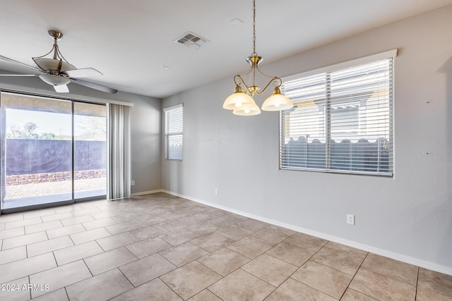 spare room with light tile patterned flooring, baseboards, visible vents, and ceiling fan with notable chandelier