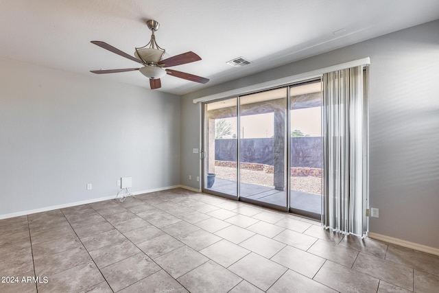 spare room with visible vents, ceiling fan, and baseboards