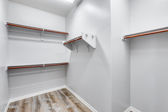 spacious closet with wood finished floors