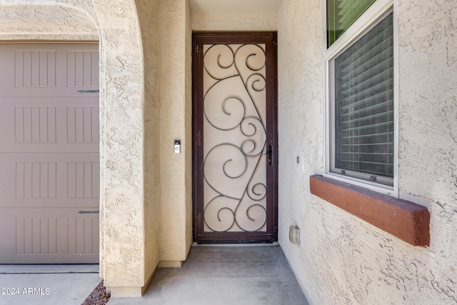 entrance to property featuring stucco siding