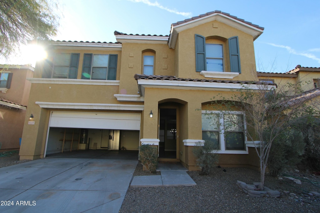 mediterranean / spanish-style home featuring a garage