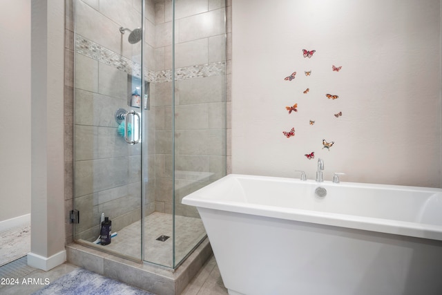 bathroom featuring separate shower and tub and tile patterned flooring