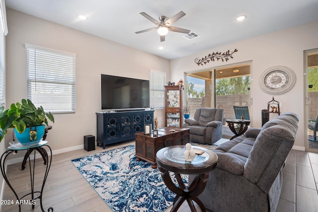 living room featuring ceiling fan and light hardwood / wood-style flooring