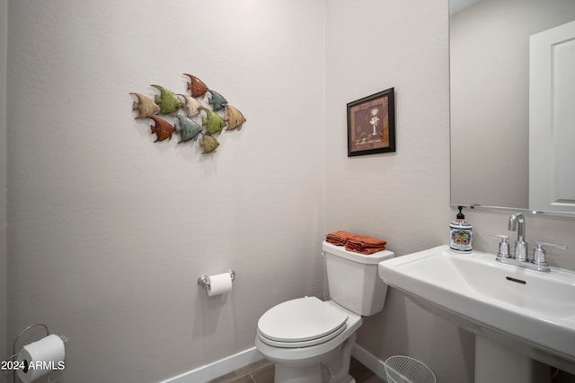 bathroom featuring tile patterned floors, toilet, and sink