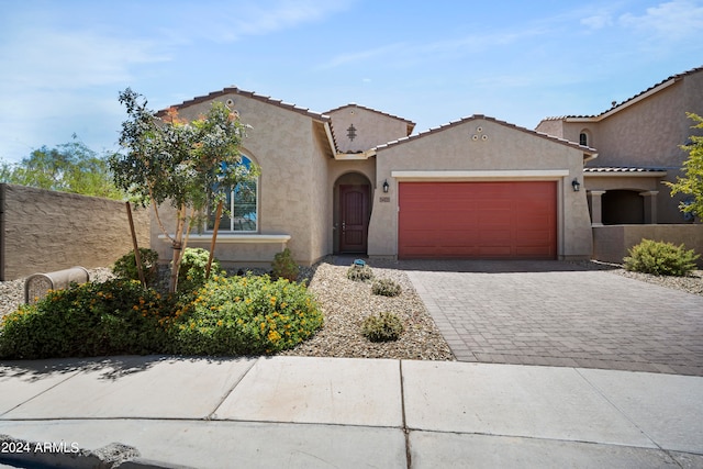 mediterranean / spanish-style home featuring a garage