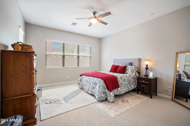 bedroom with light carpet and ceiling fan